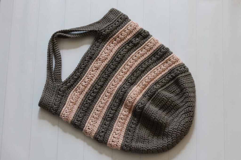 A pink and grey striped crochet market bag