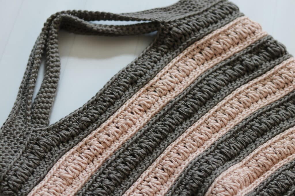 A close up of the handles of the Downtown Crochet Market Bag