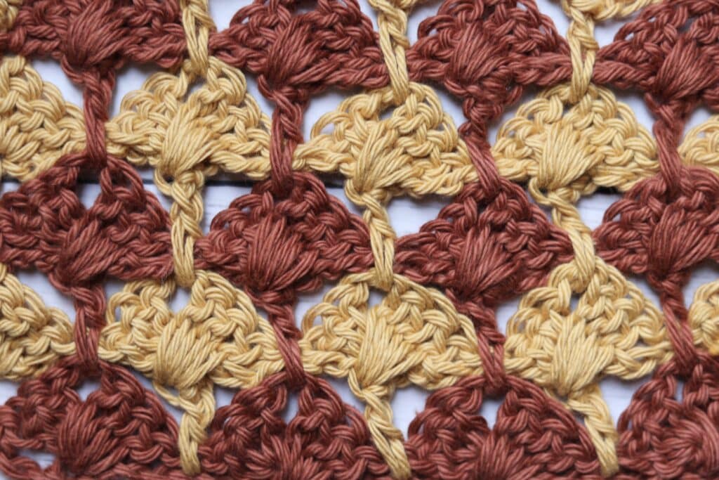 The Crossed Box Crochet Stitch worked in brown and yellow yarn