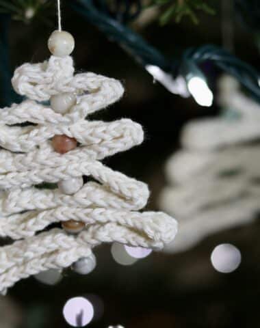A crochet ribbon tree hanging on a Christmas tree