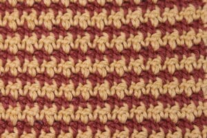 The houndstooth crochet stitch worked in a gold and rust coloured yarn