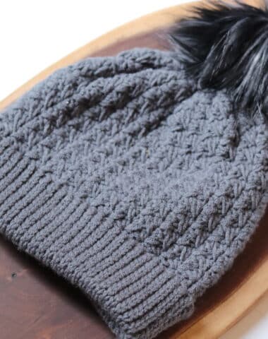 A textured crochet beanie worked in a slate grey yarn