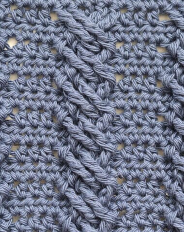 A swatch of the crochet twisted cable stitch worked in blue yarn