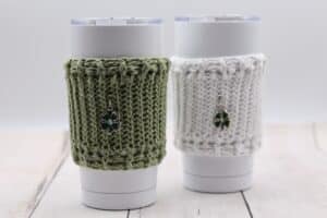 Green and white textured cup cozies featuring shamrock charms