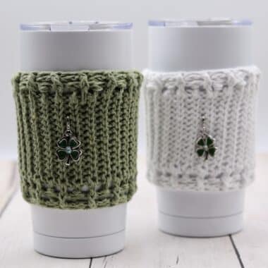 Green and white textured cup cozies featuring shamrock charms