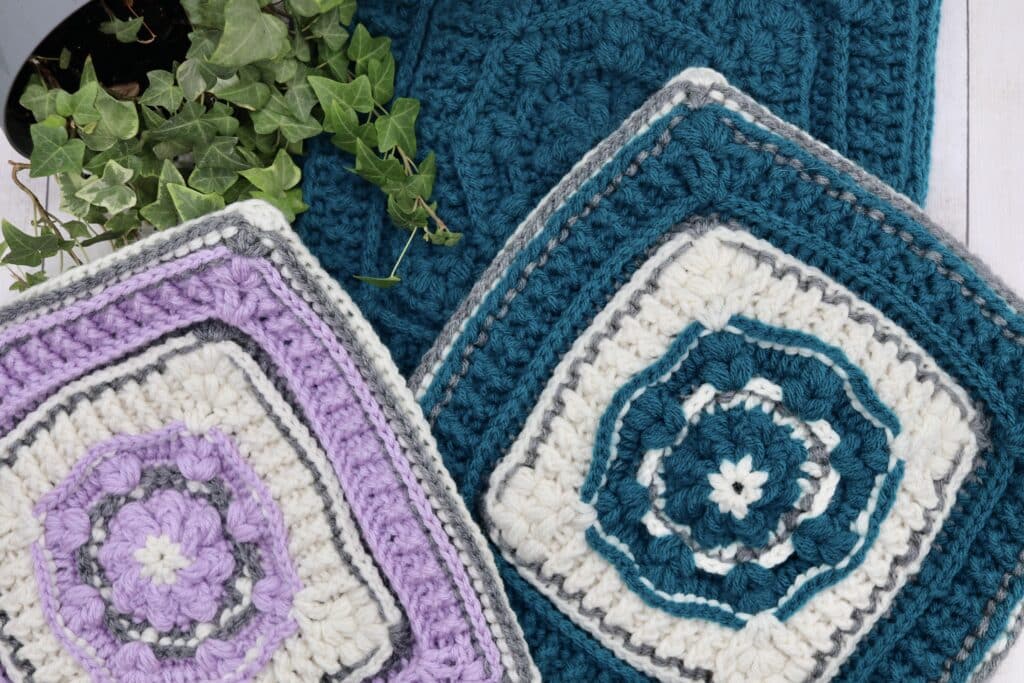 A collection of crochet afghan squares worked in a variety of colours