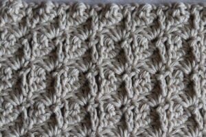 The Boxed Cluster Stitch worked in a off white coloured yarn