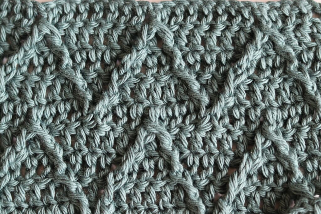 The ripple cable crochet stitch worked in a green coloured yarn