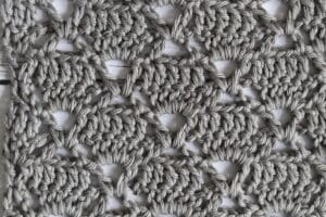 A Crochet Lace stitch pattern featuring a diamond design