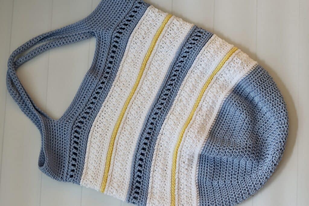 A blue, white and yellow textured crochet market bag