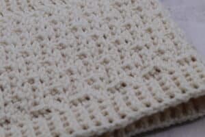 A close up of the edging of a textured crochet cowl