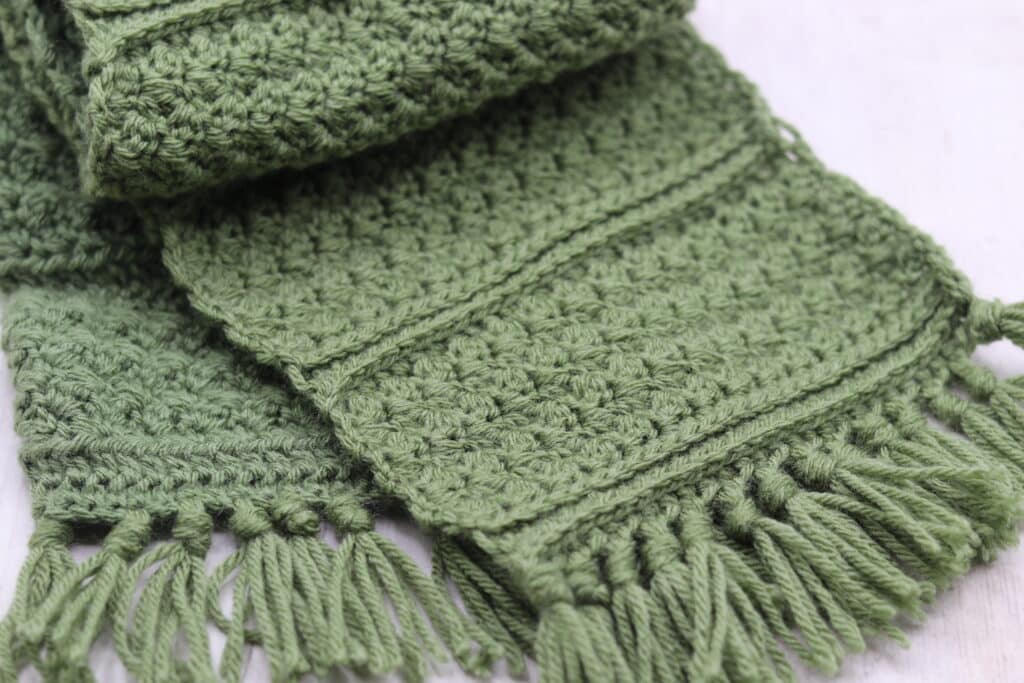 A close up of the texture and fringe on the crochet Adelaide Scarf
