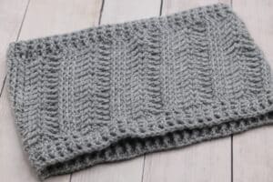 A textured crochet cowl worked in a grey yarn