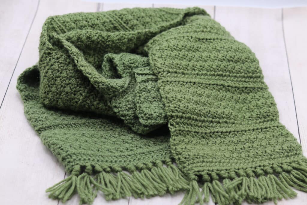 A textured crochet scarf worked in a green yarn