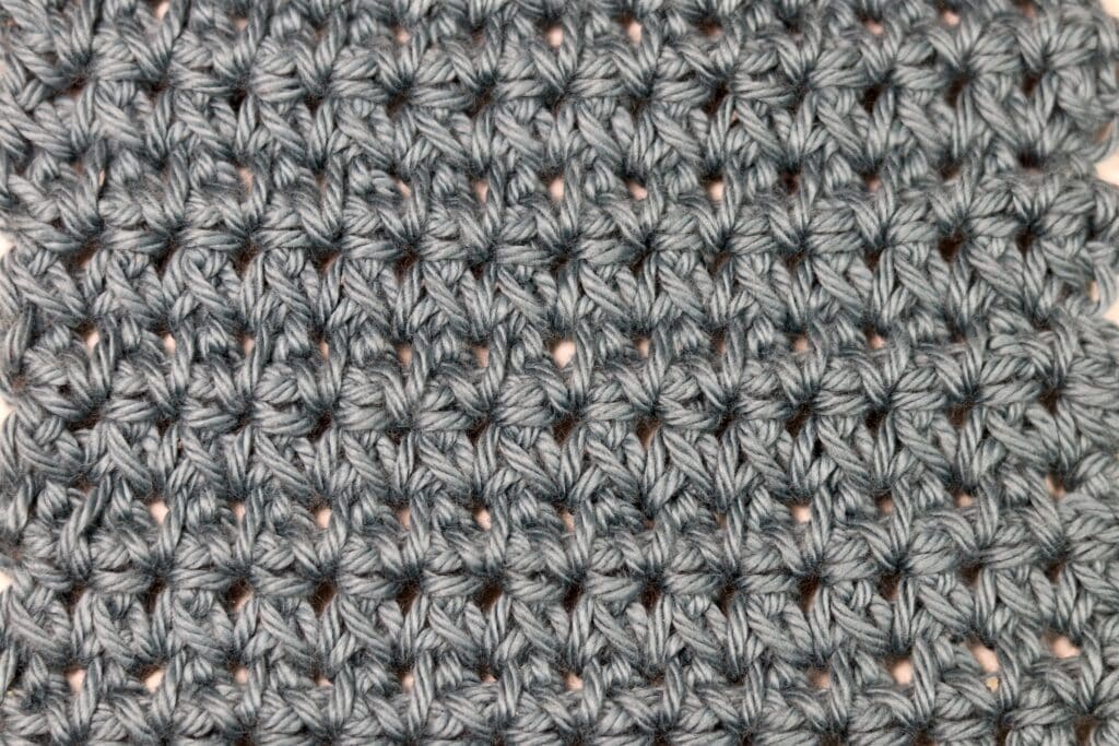 A star crochet stitch worked in a grey yarn
