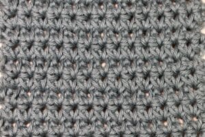 A star crochet stitch worked in a grey yarn