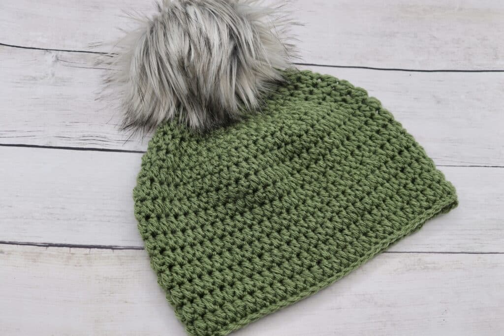 A textured crochet hat worked in a green coloured yarn