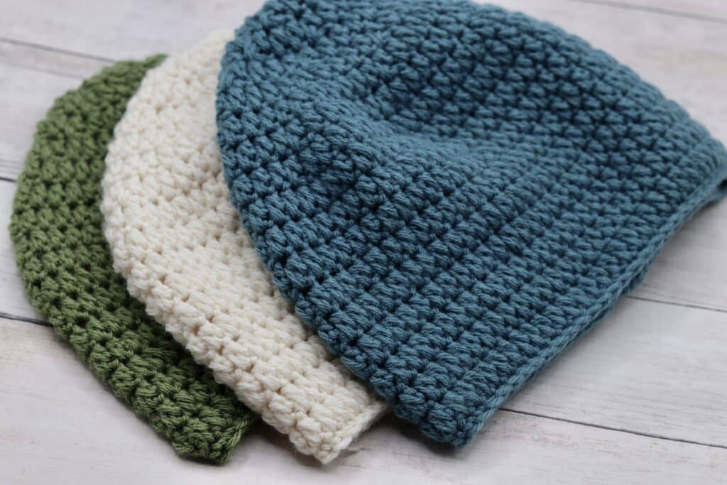 A set of three textured crochet hats