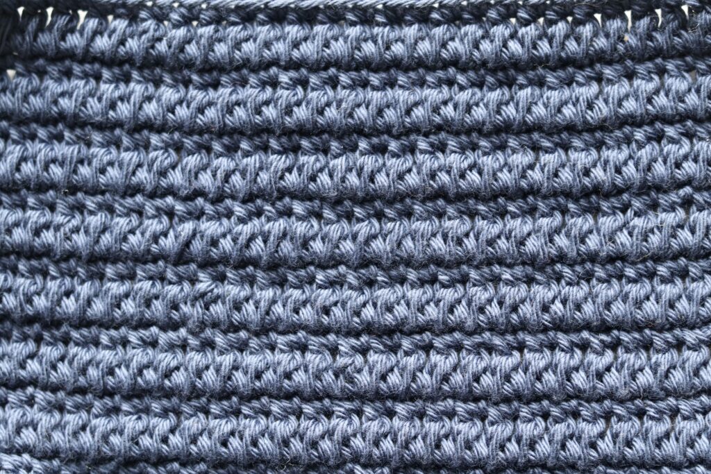 A textured crochet stitch pattern that creates a solid fabric