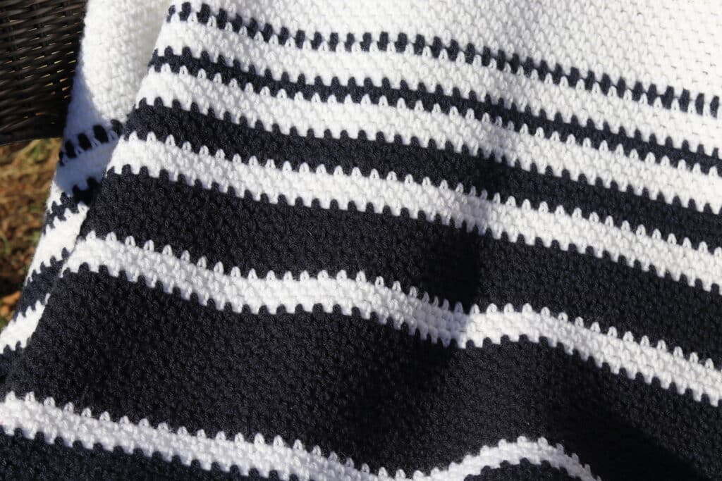 A close up of the colour and stitch pattern in the crochet nautical throw