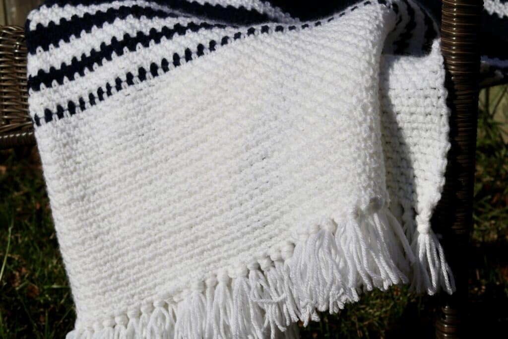 A close up of the fringe of the crochet Nautical Throw