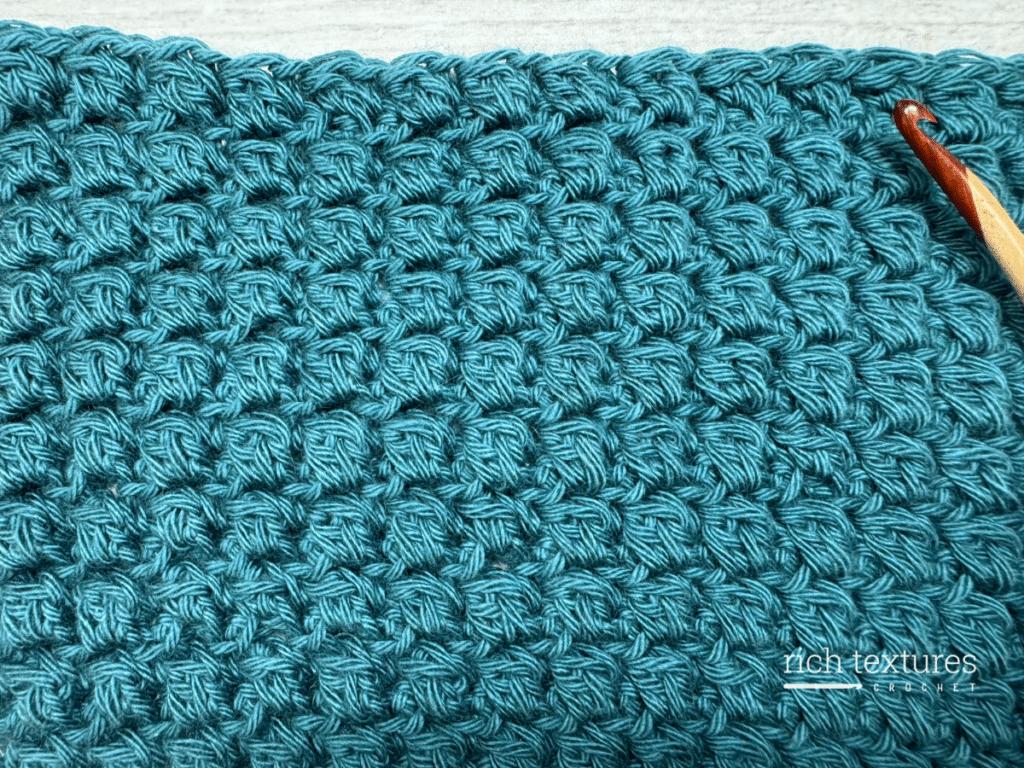 A swatch of the crochet gravel stitch green yarn