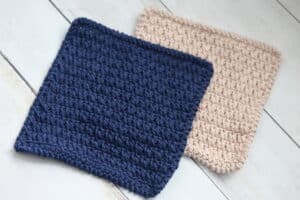 Two crochet dishcloths laid flat on a white surface.