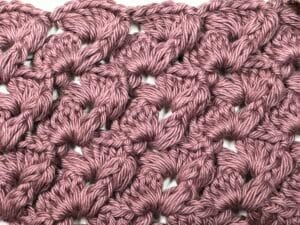 A swatch of the Rosebud Crochet Stitch worked in pink yarn