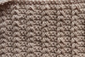 A swatch of the field crochet stitch worked in a peach colour
