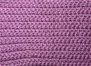 A swatch of the sable stitch crochet pattern worked in a pink yarn