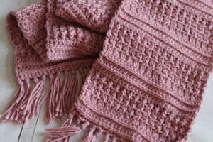 The Deep River crochet scarf worked in a pink yarn