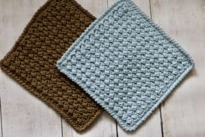 Two crochet dishcloths placed on a table