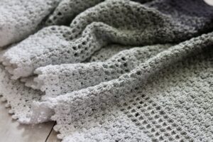 The Long Island Crochet Shawl laid on a flat surface