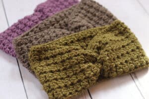 A collection of 3 crochet ear warmers featuring a twist at the front
