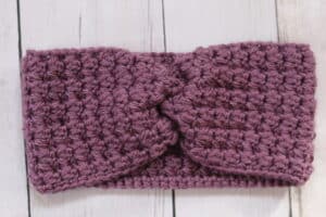 The Country Ear Warmer worked in a purple yarn
