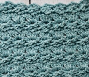 A swatch of the crochet cabbage stitch worked in blue yarn