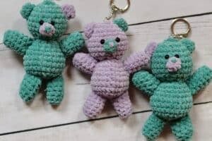 three crochet teddy bear keychains